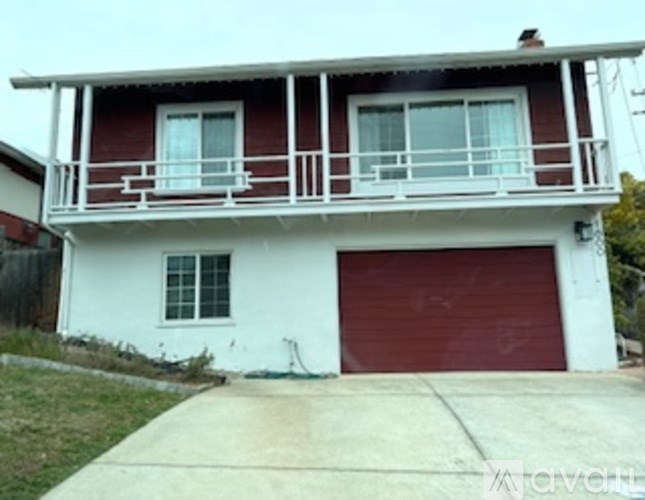 A two-story house with a red garage door.