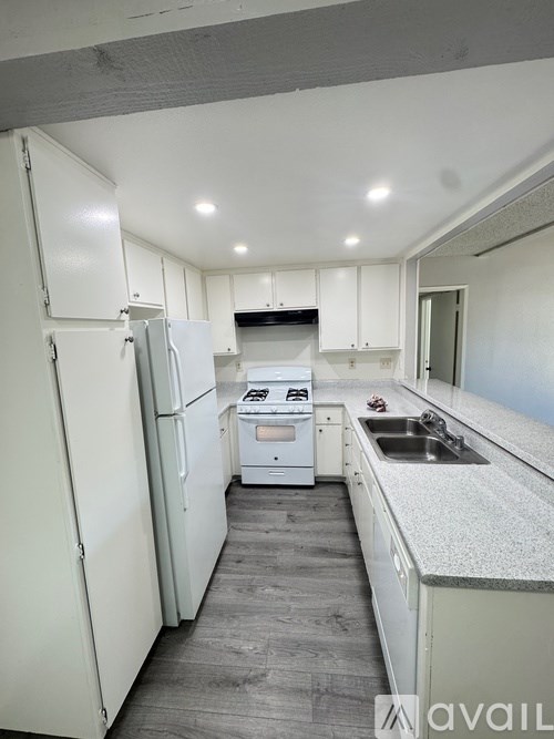 A large outdoor swimming pool with a house in the background.