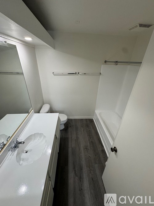 A bathroom with a toilet, sink, and bathtub.