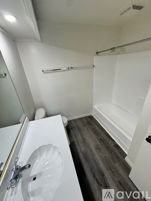 A room with a wooden floor and white walls.