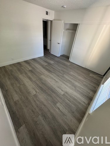 A room with a wooden floor and white walls.