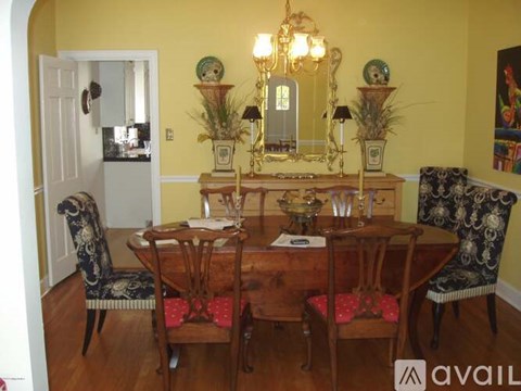 A dining room with a wooden table and chairs.