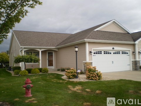 A house with a red fire hydrant in front of it.