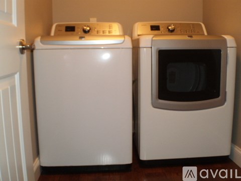 Two white ovens are in a corner of a room.