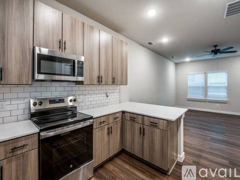 A kitchen with wooden cabinets and a stainless steel oven.