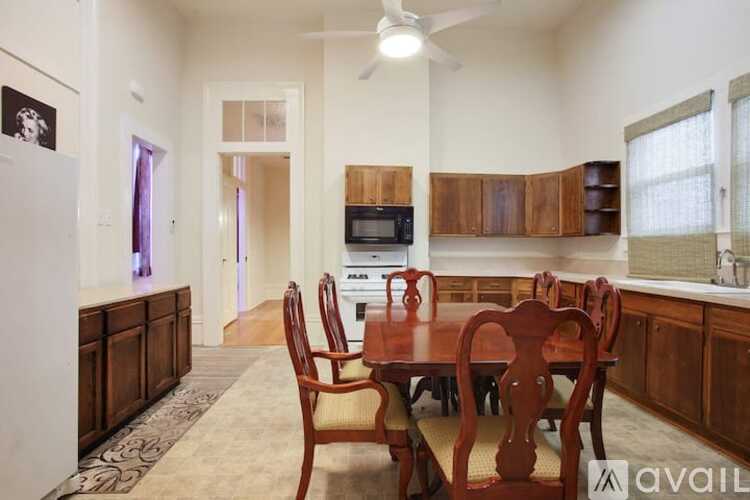 A kitchen with a table and chairs in the middle of the room.