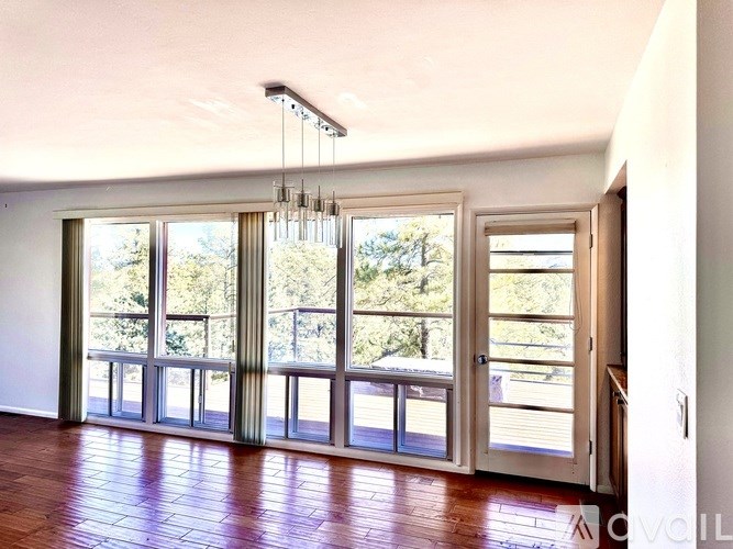 A room with a balcony and a chandelier.