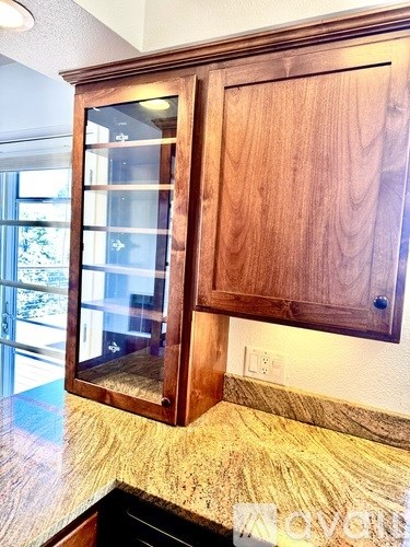 A wooden cabinet with a glass door is in the foreground.