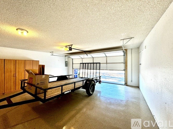 A room with a wooden door and a white wall with a window.