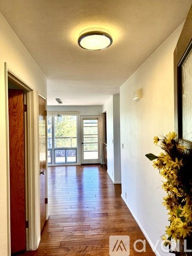 A hallway with a flower arrangement on the right side.