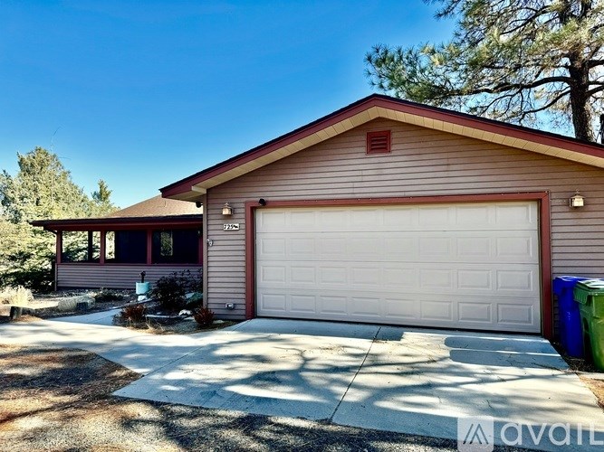 A house with a garage door and a driveway.