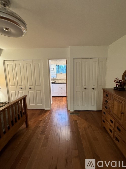 A room with wooden floors and white doors.