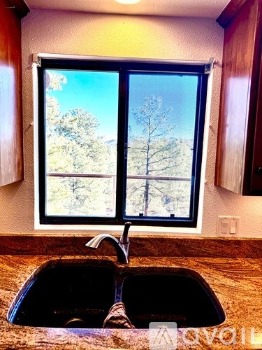 A kitchen with a sink and a window.