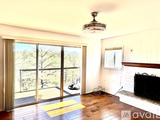 A living room with a fireplace and sliding glass doors.