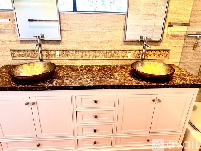 A bathroom with two sinks and a countertop.