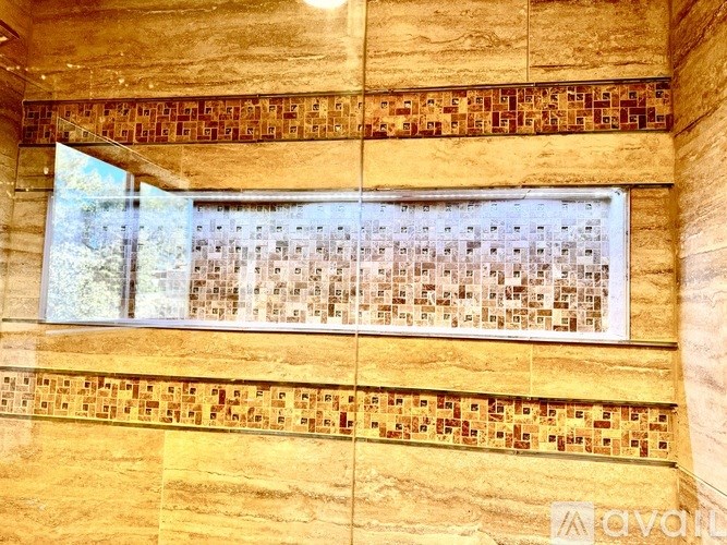 A wall with a row of windows and a row of tiles.