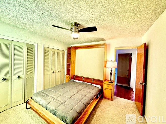 A bedroom with a bed, dresser, and closet.