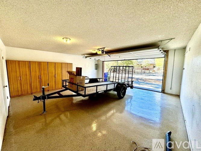 A room with a wooden wall and a cart with boxes on it.