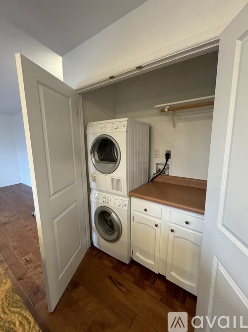 A small laundry room with a washer and dryer.