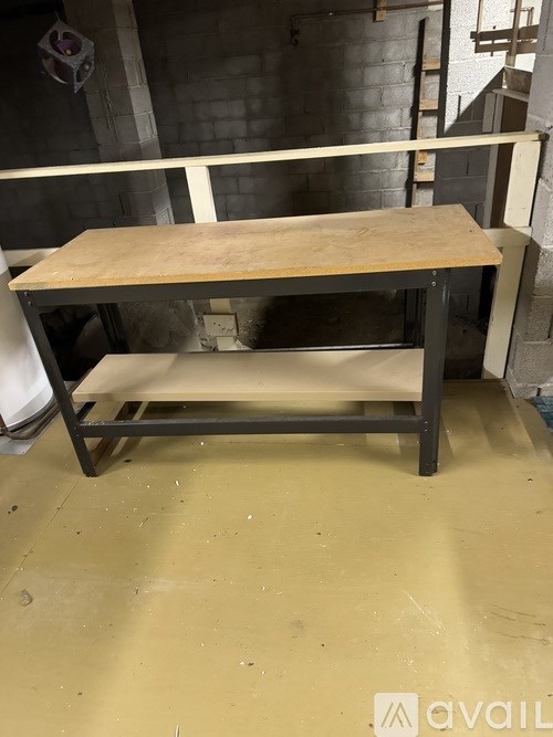 A wooden table with a metal frame and a white cloth on it.