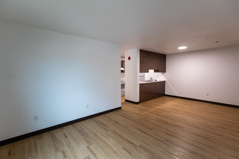 A room with wooden floors and white walls.