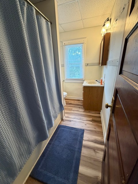 A blue bathroom mat is on the floor.