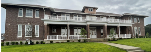 A large house with a porch and a covered entrance.