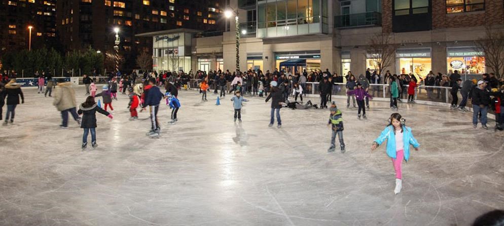 a crowd of people ice skating on a rink