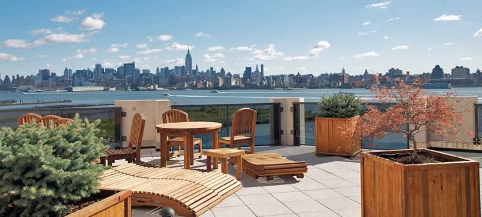 a balcony with a table and chairs and a view of the city