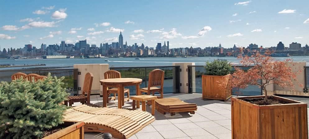 a balcony with a table and chairs and a view of the city