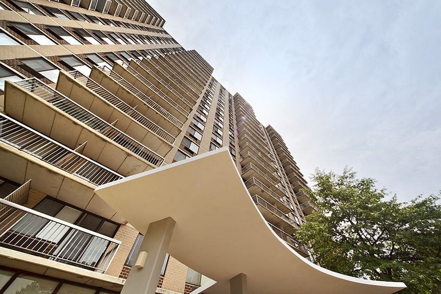 a tall building with a sculpture in front of it