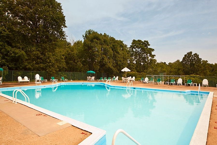 a large swimming pool with chairs around it