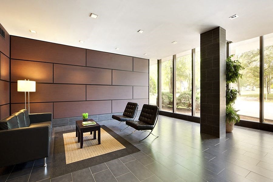 a living room with two black chairs and a table