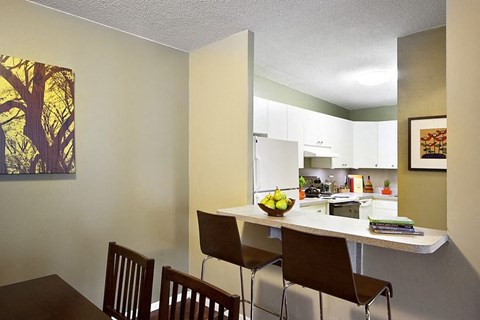 a kitchen and dining room with a table and chairs