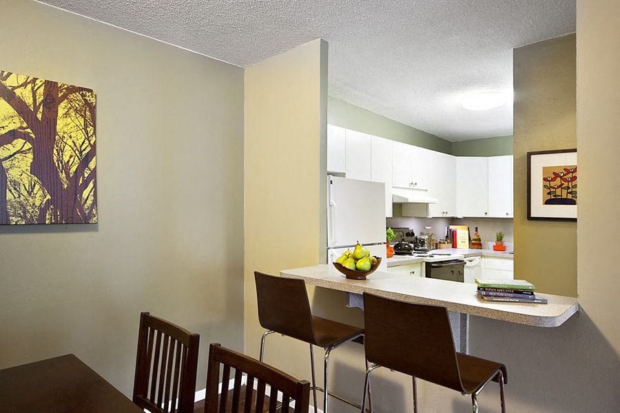a kitchen and dining room with a table and chairs