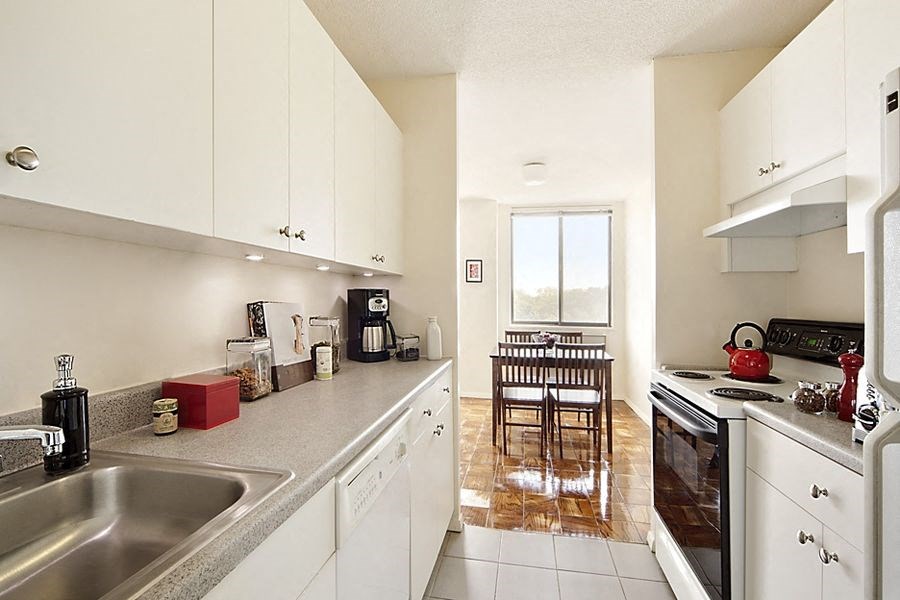 a kitchen with a sink and a stove and a table