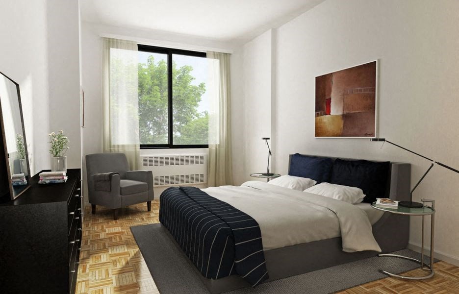 a bedroom with a bed and a chair and a window