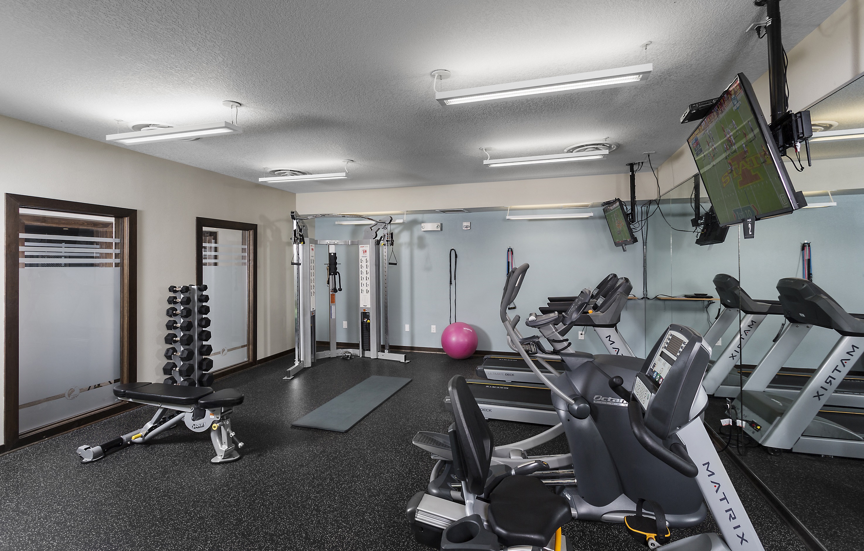 fitness center with weights and cardio equipment