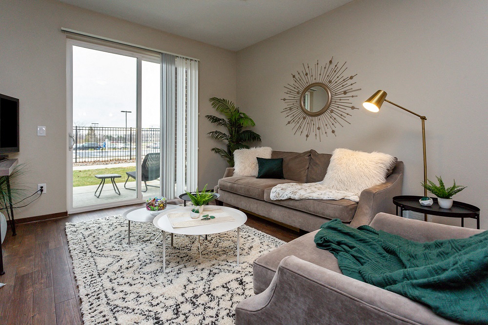 living room with doors to patio, couch, and coffeetable