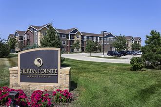 an apartment building with a sign pointe apartments