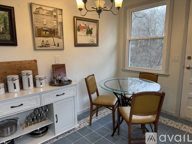 A dining room with a glass table and chairs.