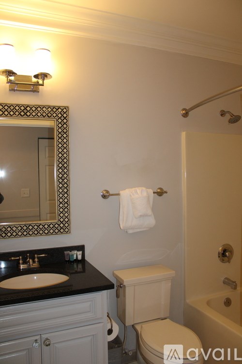 A bathroom with a sink, toilet, and bathtub.