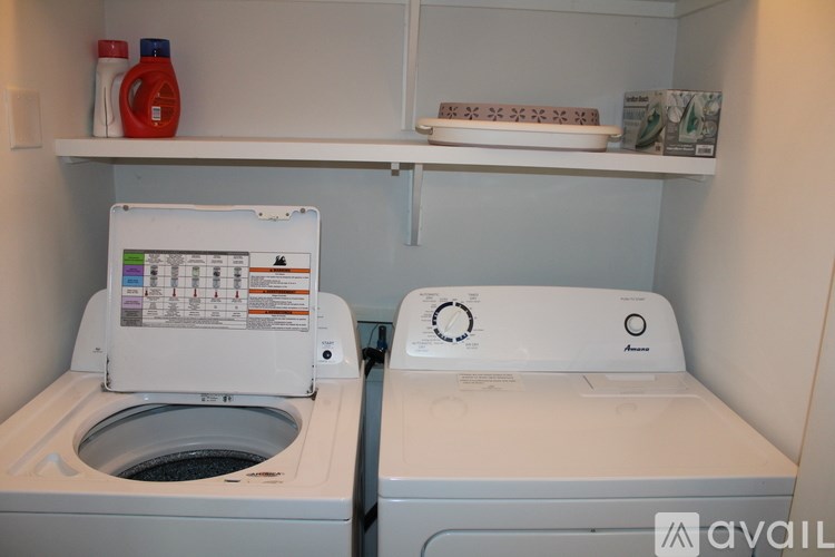 A white washing machine and dryer in a small laundry room.