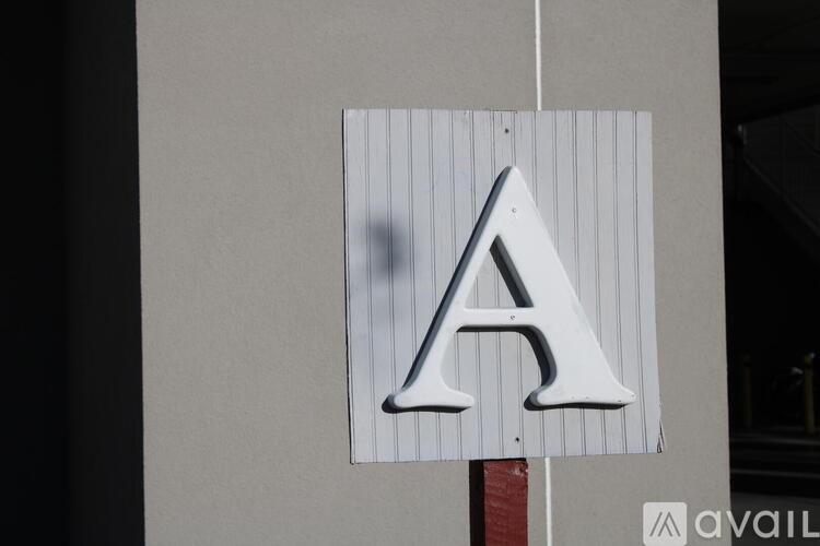 A sign with a white letter A on a grey background.