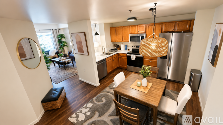 A kitchen with wooden cabinets and a black countertop.
