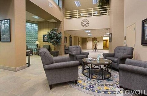 A living room with grey chairs and a coffee table.