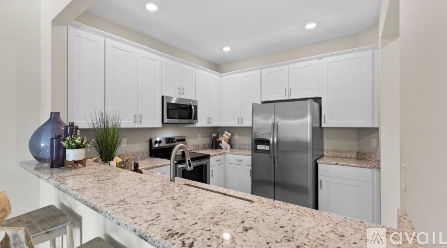 A kitchen with granite countertops and stainless steel appliances.