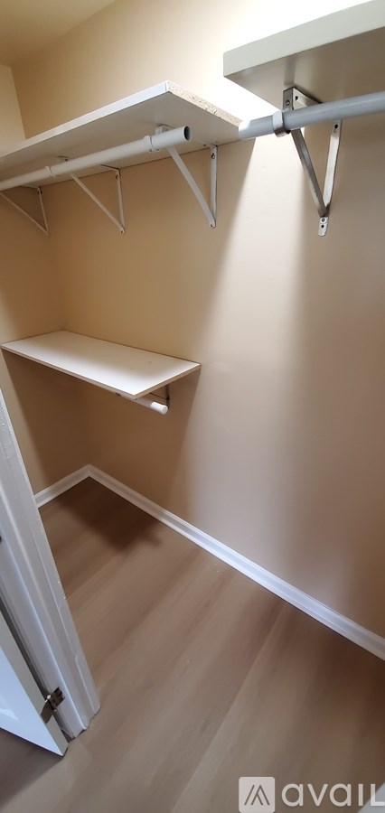 A white shelf is mounted on a wall.
