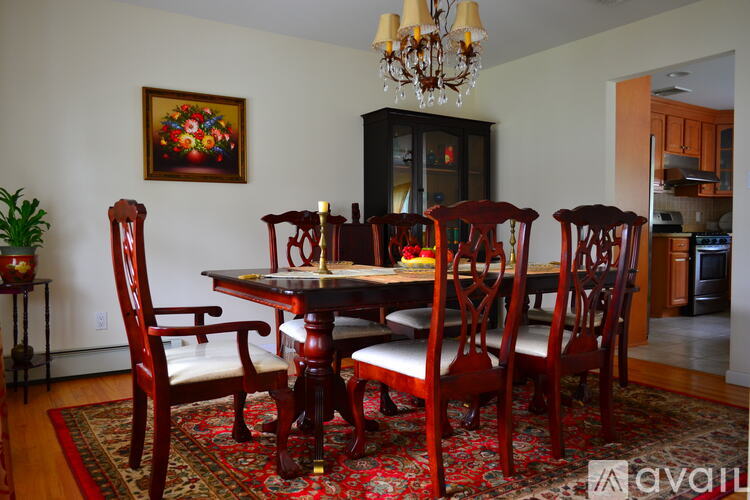 A dining room with a wooden table and chairs.