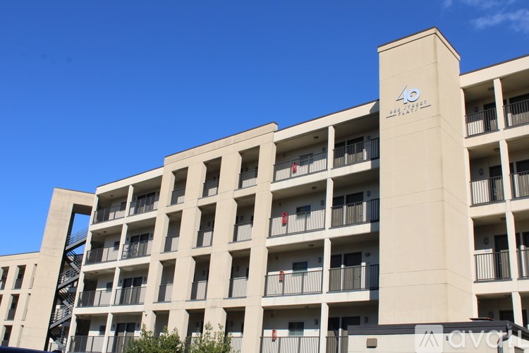 A tall building with balconies and a sign that reads "40".